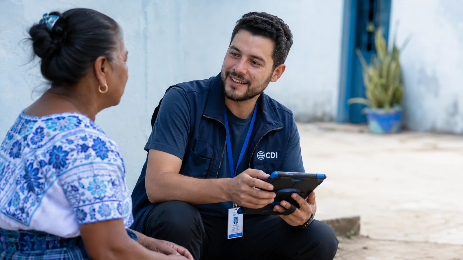 A field researcher collecting survey responses on a tablet